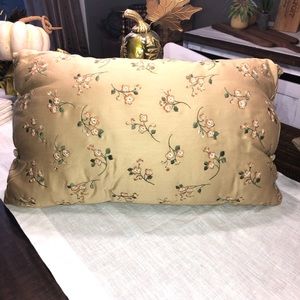 Decorative pillow w/embroidered delicate flowers. Has buttons on the side